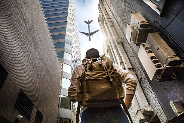 What is your next travel destination? Woman looking a plane What is your next travel destination? Woman looking a plane in downtown Chicago, USA. exploring Illinois stock pictures, royalty-free photos & images